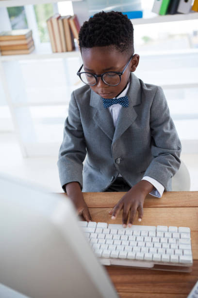 istock High angle view of businessman wearing eyeglasses using computer 825615888