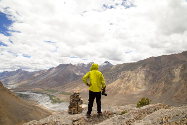 istock Successful photographer holding SLR camera on mountain 825616392