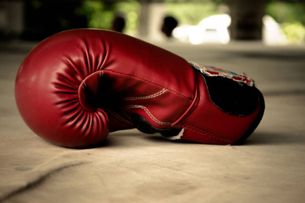 istock Old red boxing gloves on canvas 825616806