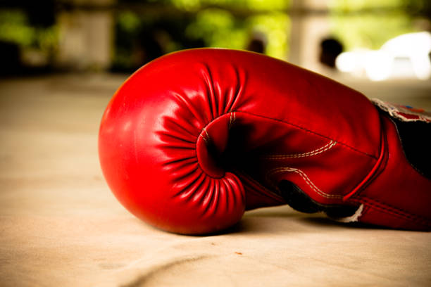 istock Old red boxing gloves on canvas 825616814