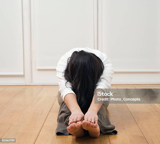 Woman Doing Forward Stretch Stock Photo - Download Image Now - Obscured Face, Yoga, 20-24 Years