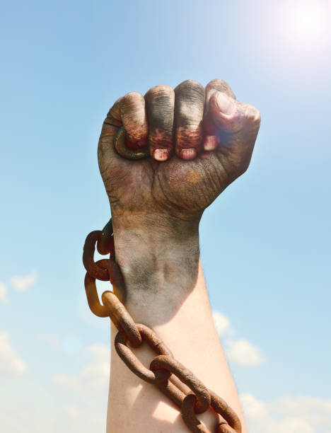 istock man's hand is encased in an iron rusty chain 825623526