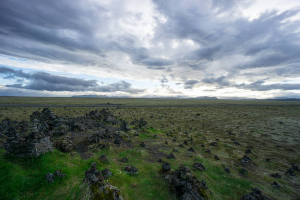 istock Iceland - Green lowlands and far mountains at dawn with clouds 825627460