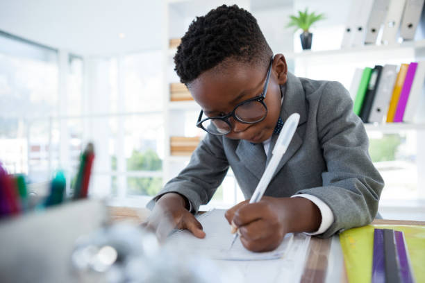 istock Businessman writing on paper at desk 825634940