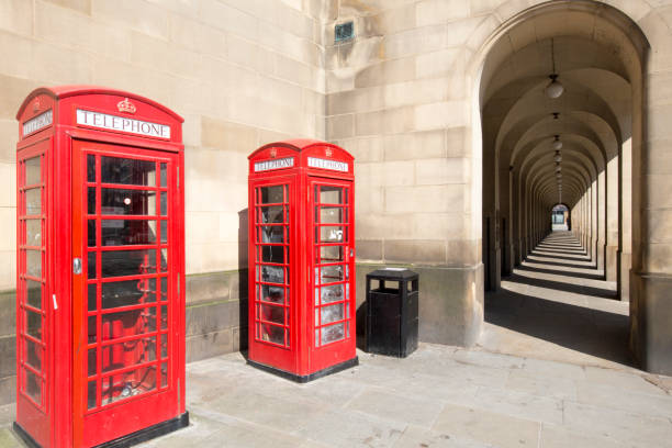 Classic British view in Manchester of old colonnades from the Manchester Town Hall Extension and iconic Red Phone Boxes