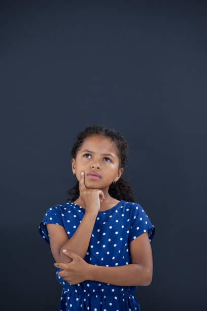 istock Contemplated girl with hand on chin 825636314
