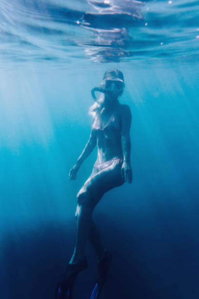 istock Beautiful woman snorkeling underwater. 825637992