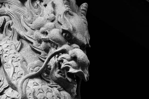istock Monocrhome Dragon sculpture on stone pole in Wong Tai Sin 825644044