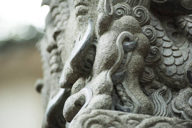 istock Close up Dragon sculpture on stone pole 825644060