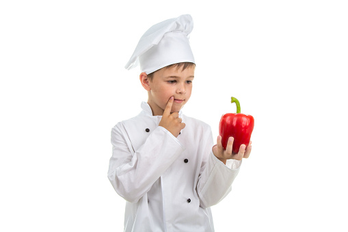 Young chef thinking about the next creative salad idea to make - isolated on white.