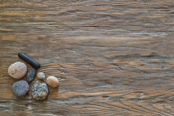Stones on an old wooden background with copy space.