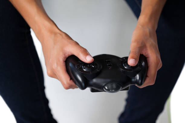 istock Woman playing video game against white background 825651500