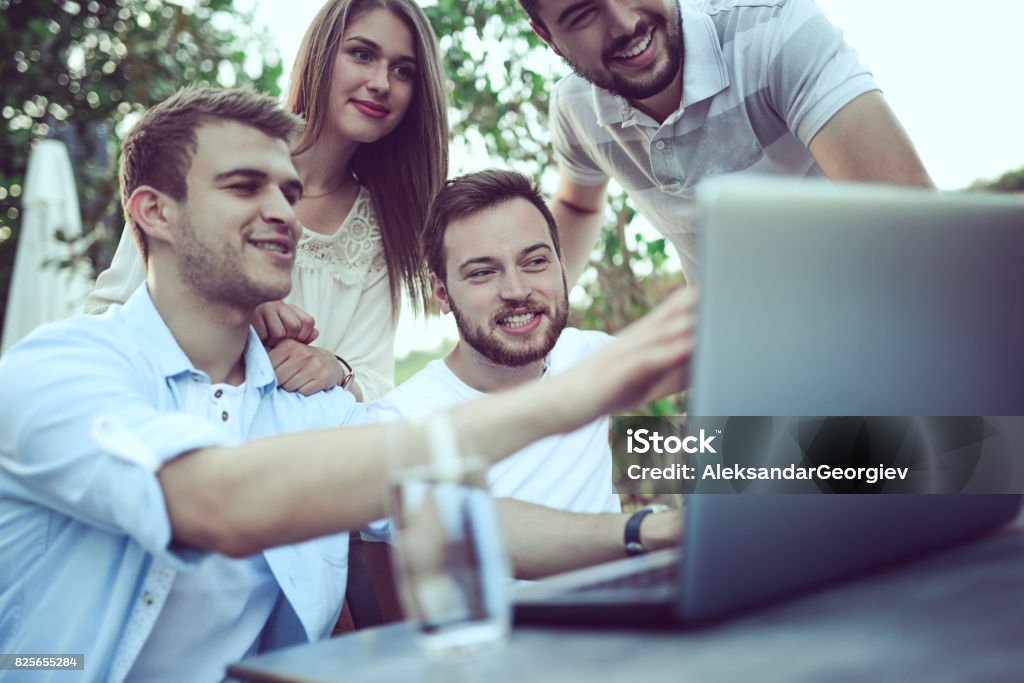 Group Young Freelancers Discussing Work in Coffee Restaurant 20-29 Years Stock Photo