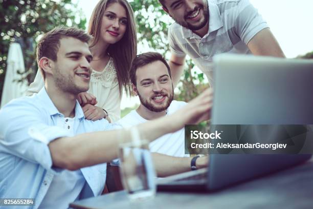 Group Young Freelancers Discussing Work In Coffee Restaurant Stock Photo - Download Image Now