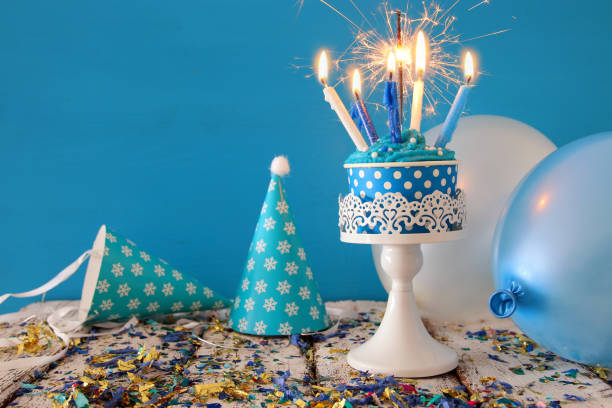 istock Birthday concept with cupcake and candles on wooden table 825655382