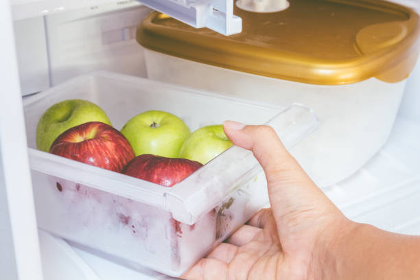 istock Hand holding apples in refrigerator ideal for diet 825658296