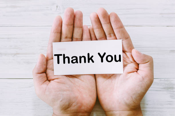 istock Paper in hand with the words thank you 825658444