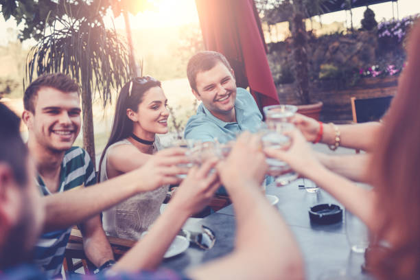 istock Group of Smiling Friends Toasting at Celebration Party 825666206
