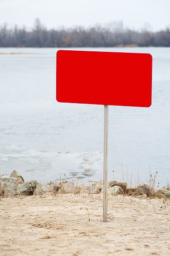 on the beach there is a prohibitory sign, an empty sign for the text