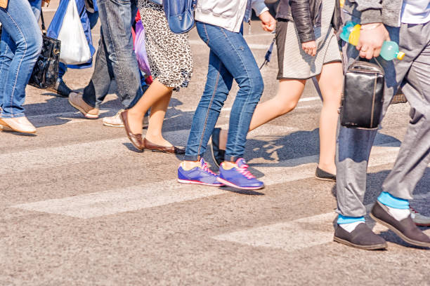istock people crossing the pedestrian crossing 825666796