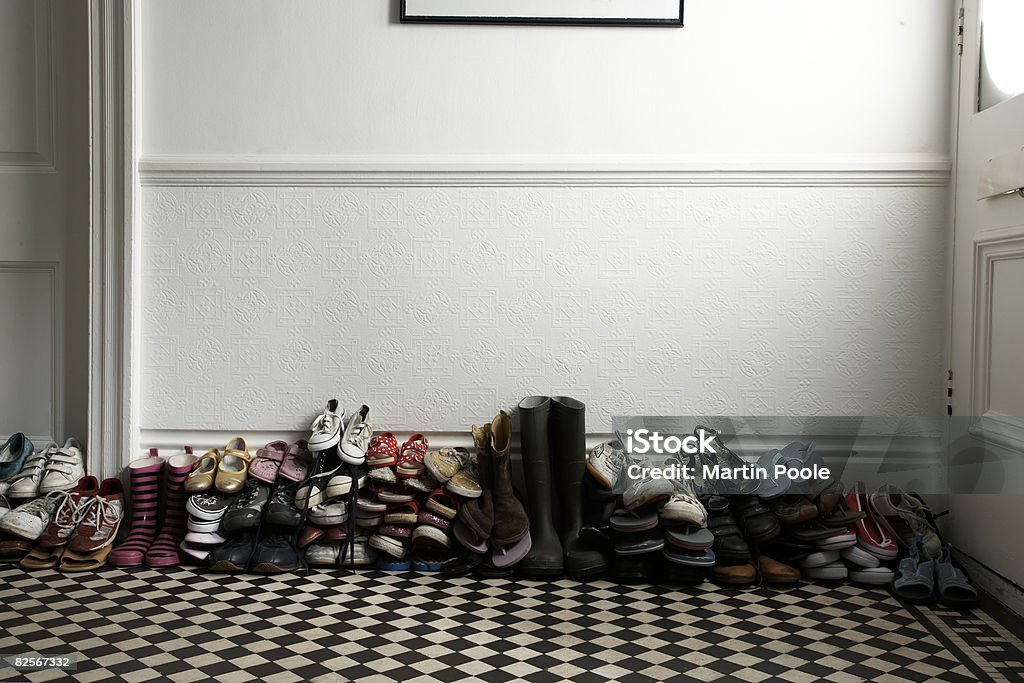 lots of different shoes stacked in hallway  Shoe Stock Photo