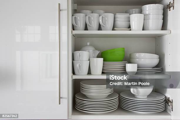 White Crockery Stacked In Cupboard With Green Bowl Stock Photo - Download Image Now - Crockery, Cabinet, Shelf