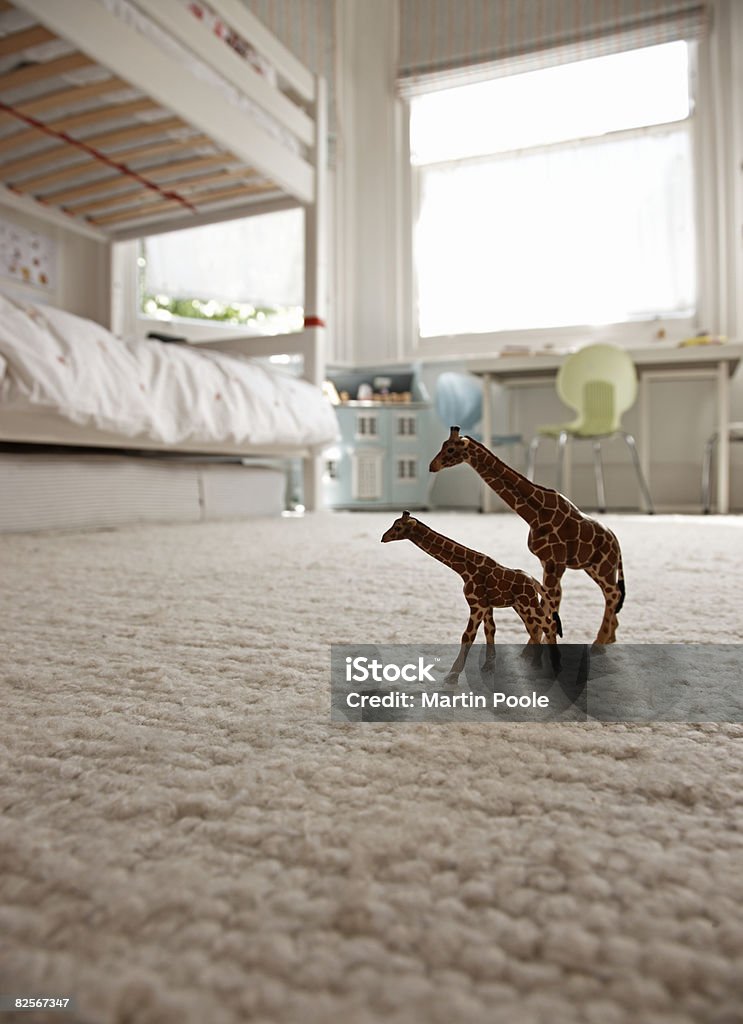 two toy giraffes on childrens bedroom floor  Carpet - Decor Stock Photo