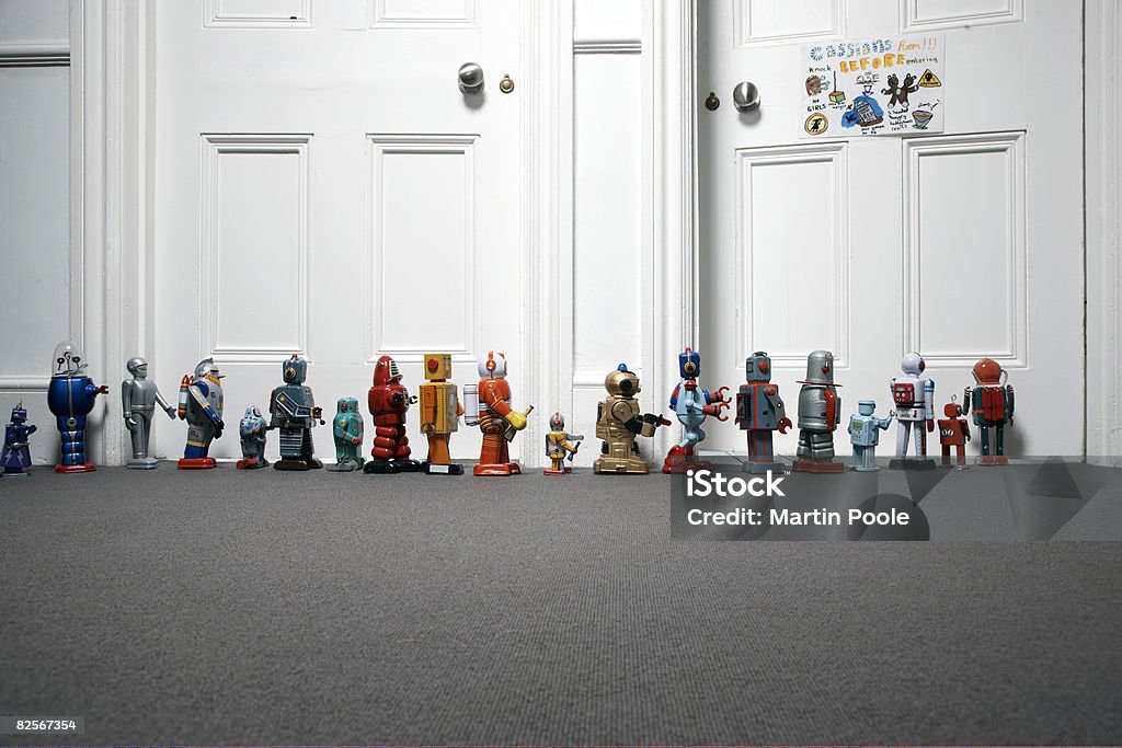 toy robots lined up outside childs bedroom  Toy Stock Photo