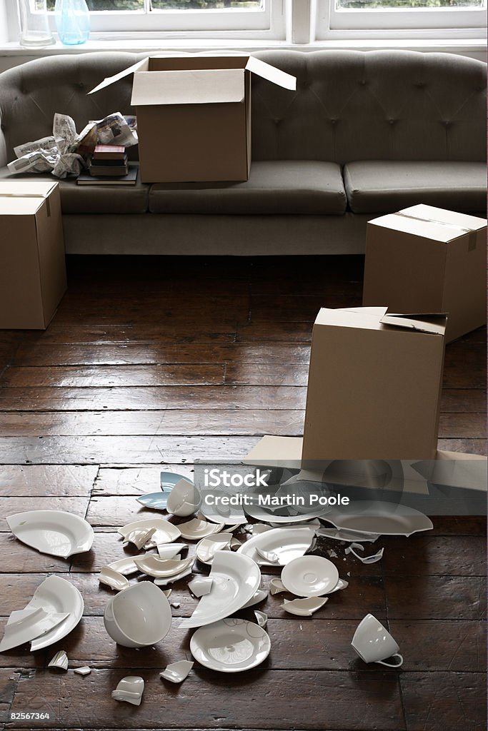 broken crockery next to cardboard box  Broken Stock Photo