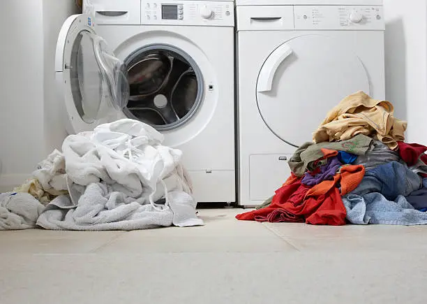 Photo of one coloured one white pile of washing