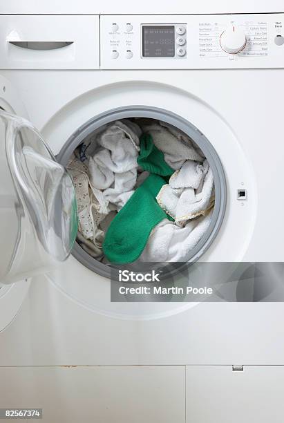 White Washing In Machine One Green Sock Stock Photo - Download Image Now - Washing Machine, Laundry, Green Color