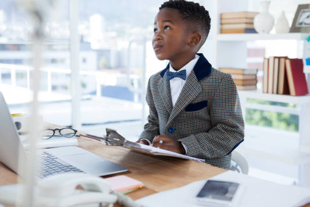 istock Thoughtful businessman with clipboard sitting at desk 825676084