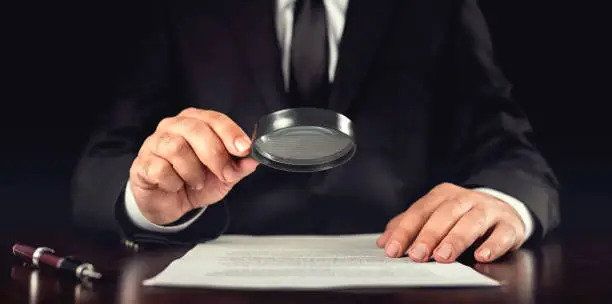 Photo of Businessman Reading Contract Details Before Signing