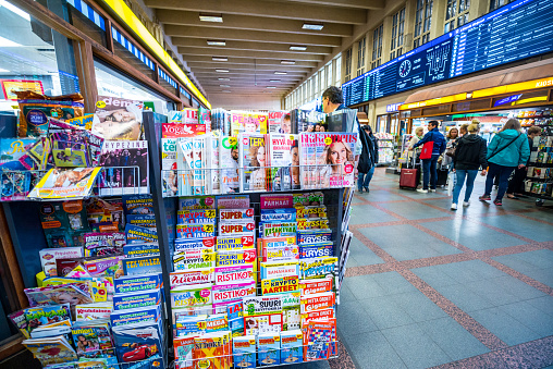 Helsinki, Finland - July 20, 2017: R-kioski shop at Helsinki Central Railway Station selling gifts, newspapers and magazines and people shopping.