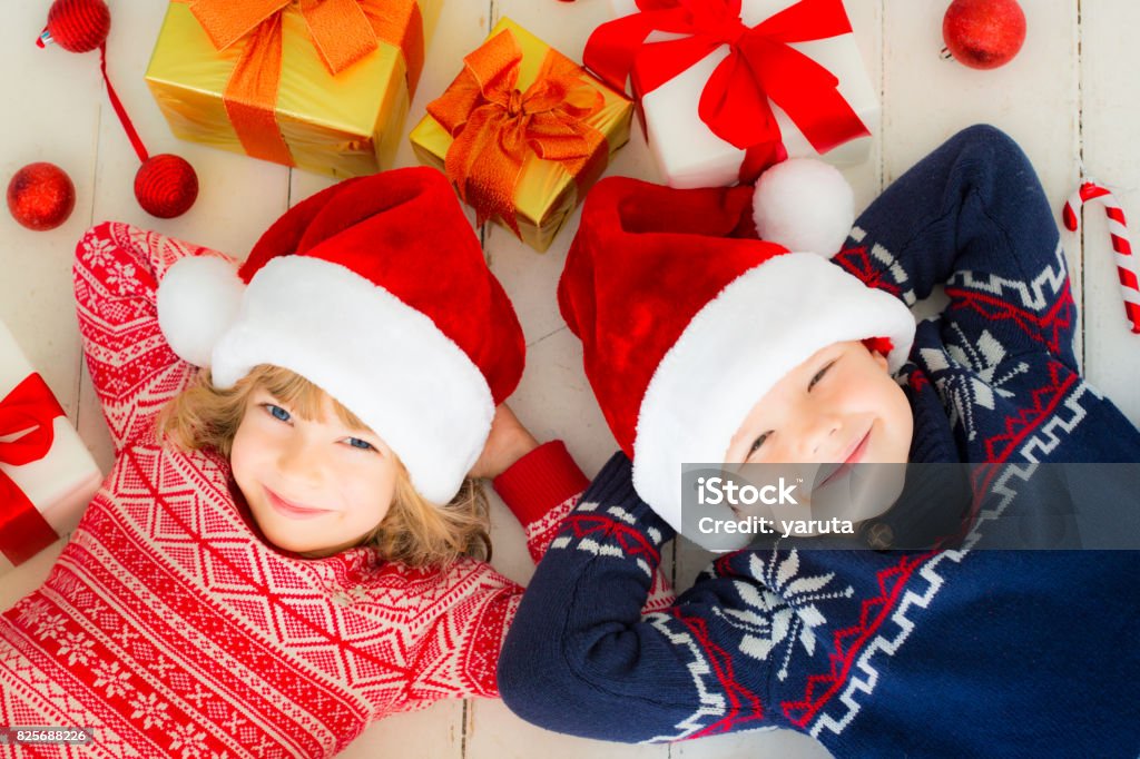 Children with Christmas decorations Portrait of happy children with Christmas decorations. Two kids having fun at home Arts Culture and Entertainment Stock Photo