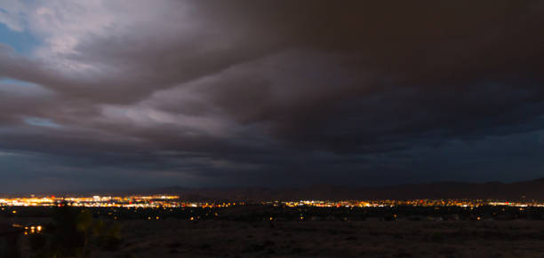 istock Storm clouds over city lights 825692370