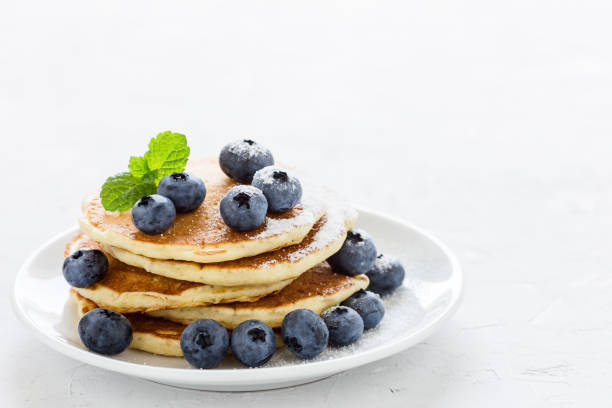 blueberry buttermilk pancakes on white plate - pancake buttermilk buttermilk pancakes equipment imagens e fotografias de stock