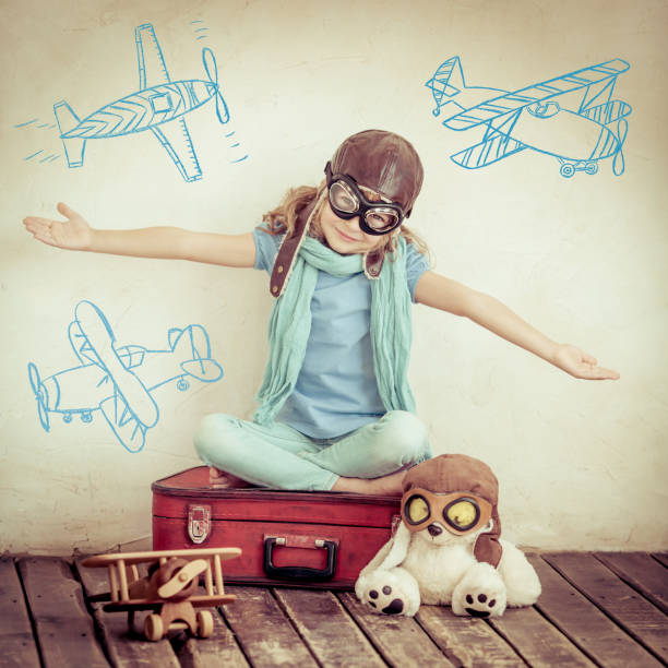 istock Happy child playing with toy airplane 825699484