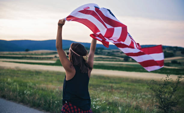 istock Woman holding USA Flag 825700866