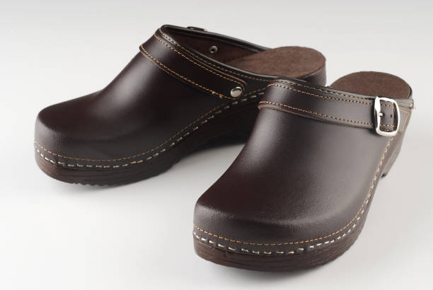 istock Beautiful modern pair of brown clogs 825701058