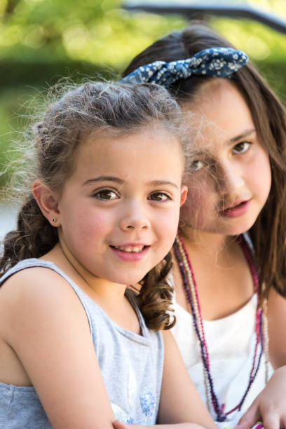 istock Two little girls posing together 825703694