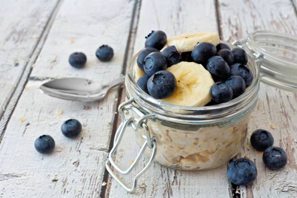 istock Overnight oats with blueberries and bananas on a white wood background 825704864
