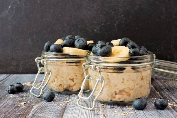 istock Overnight oats with blueberries and bananas on a dark background 825705018