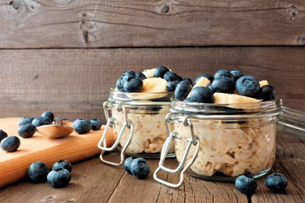 istock Overnight oats with blueberries and bananas on rustic wood 825705020