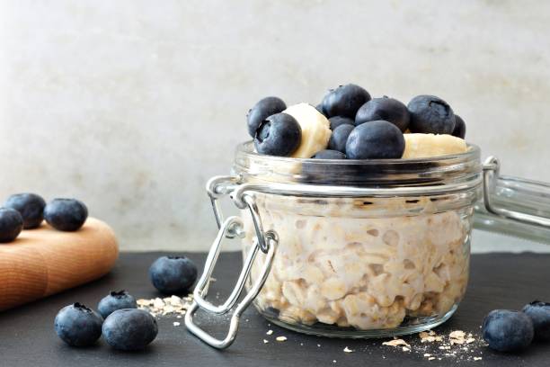 istock Overnight oats with blueberries and bananas, with white and black background 825705052