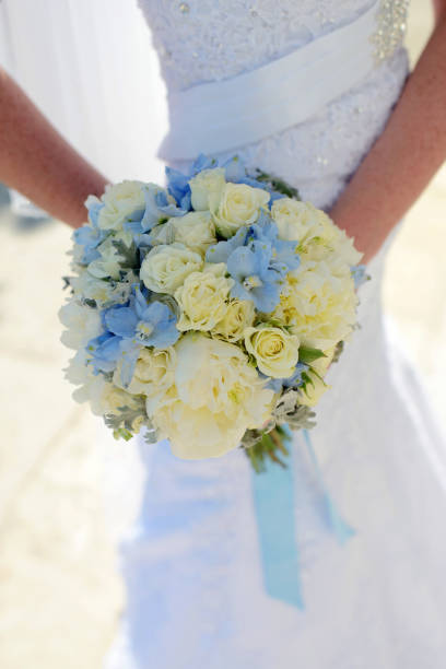 istock Beautiful bride is holding a wedding colorful bouquet 825705298