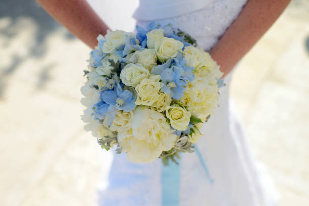 istock Beautiful bride is holding a wedding colorful bouquet 825705488
