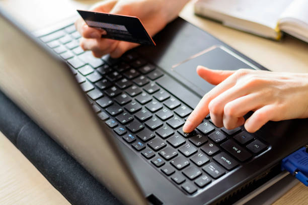 istock Hands holding credit card and using laptop. Online shopping 825705784