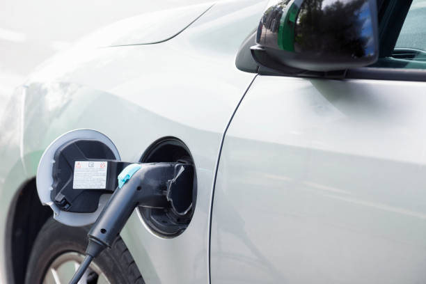 istock Electric car plugged in charging 825711854