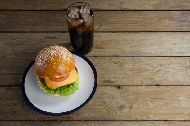 istock Hamburger in plate with glass of cold drink 825714506